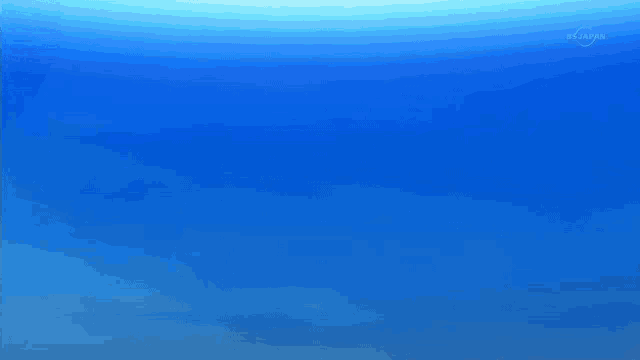 two soccer balls are flying in the air in front of a blue background that says tokyo