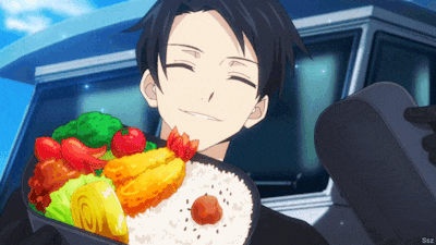 a man in a suit is holding a bento box with rice and vegetables in it