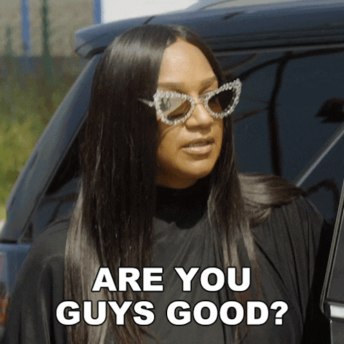 a woman wearing sunglasses and a black shirt says are you guys good