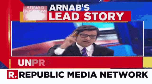 a man in a suit and tie is talking on a cell phone in front of a r. republic media network advertisement