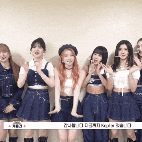 a group of girls standing next to each other with kepler written on the bottom right