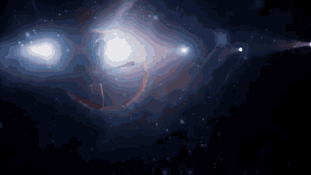 a woman is dancing in a dark room in front of a galaxy .