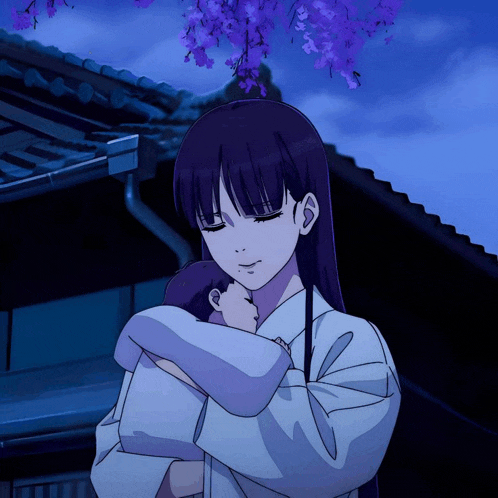 a woman is holding a baby in her arms with purple flowers in the background