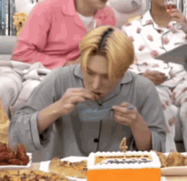 a man is sitting at a table eating a cake .
