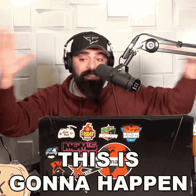 a man wearing headphones stands in front of a microphone with the words " this is gonna happen "