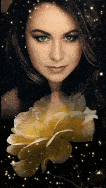 a close up of a woman 's face with a yellow flower in the foreground