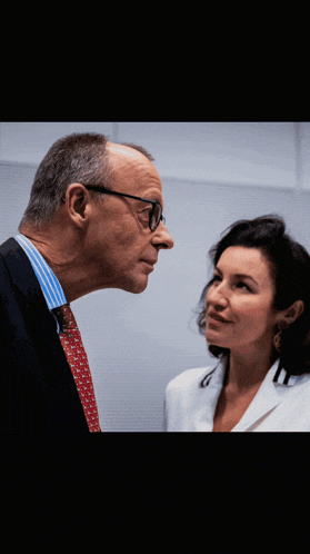 a man and a woman are looking at each other with their eyes closed