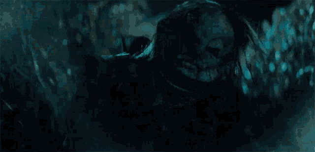 a close up of a person 's face in the dark