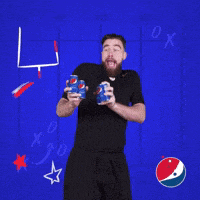 a man in a black shirt is holding a pepsi bottle