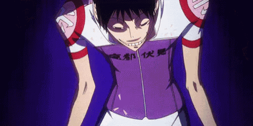 a man in a purple shirt with chinese writing on it is smiling .