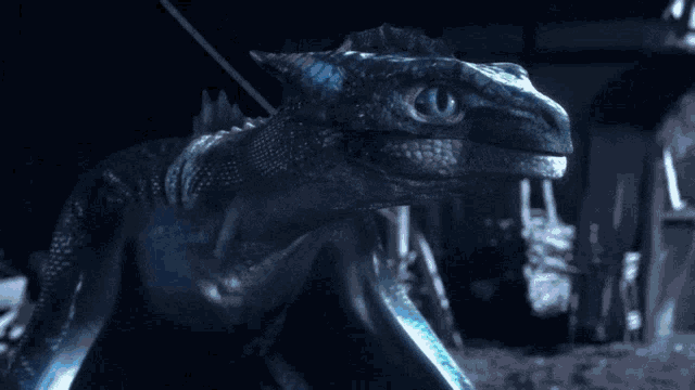 a close up of a blue monster with a rope hanging from it