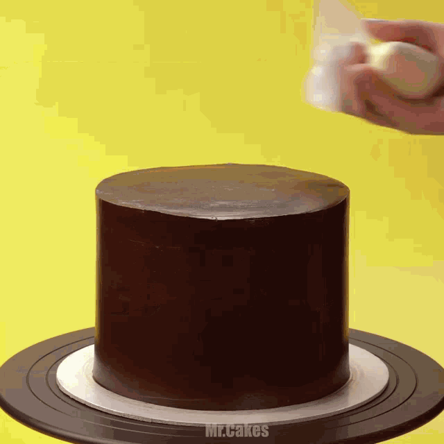 a chocolate cake is being decorated by mr cakes
