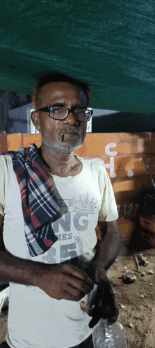 a man wearing glasses and a shirt that says king