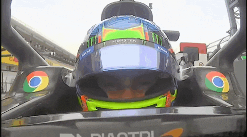 a race car with a monster energy helmet on it