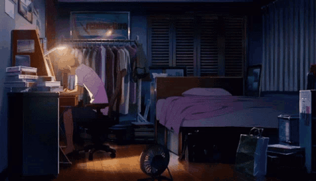 a man sits at a desk in a bedroom with a sign on the wall that says " fighter king "