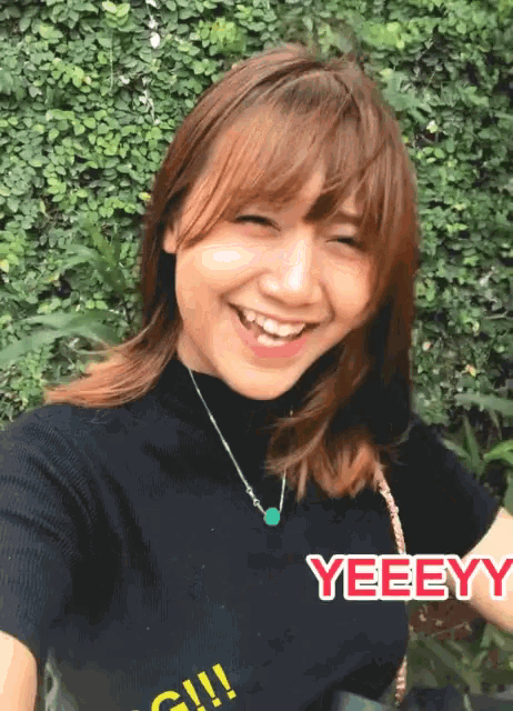 a woman wearing a black shirt that says yeeey on it