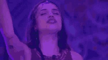 a woman with purple hair is holding her hand to her chin and the words friday feeling are above her