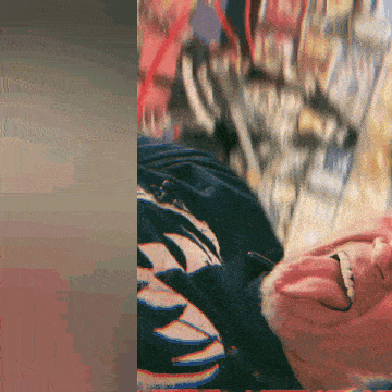 a close up of a man 's face with his tongue hanging out and a blurry background