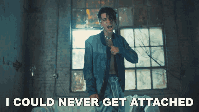 a man in a denim jacket with the words i could never get attached