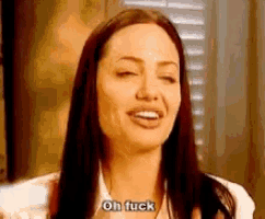 a woman with long dark hair is making a funny face and saying `` oh fuck '' .
