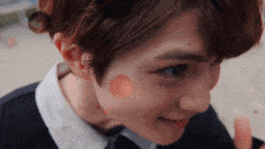 a close up of a person 's face with a circle on it .