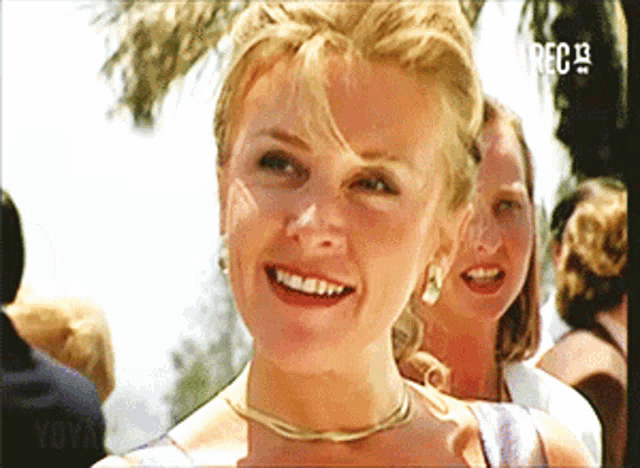 a woman is smiling in front of a screen that says ' rec 13 '