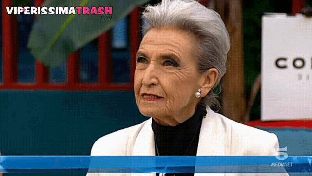 a woman with gray hair is on a tv screen with the words viperissima trash