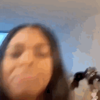 a blurry picture of a woman 's face is being taken in a car .