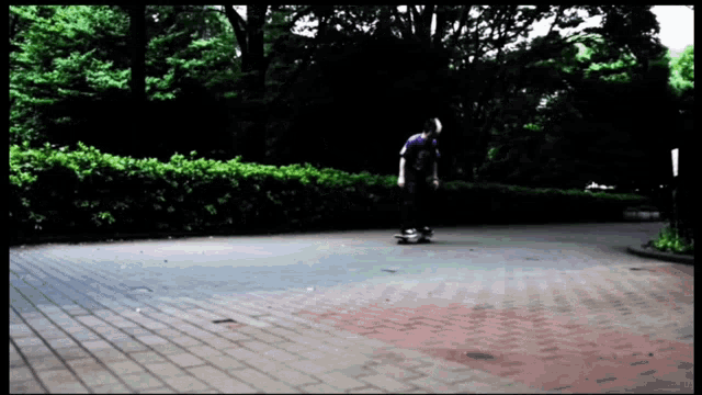 a person is riding a skateboard on a brick road