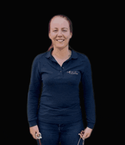 a woman wearing a blue shirt that says ' veterinary clinic ' on the front