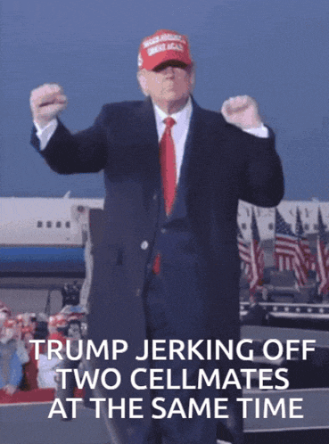 a man in a suit and tie is wearing a trump hat