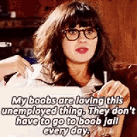 a woman sitting on a couch with a sign that says " my boobs are loving this unemployed thing