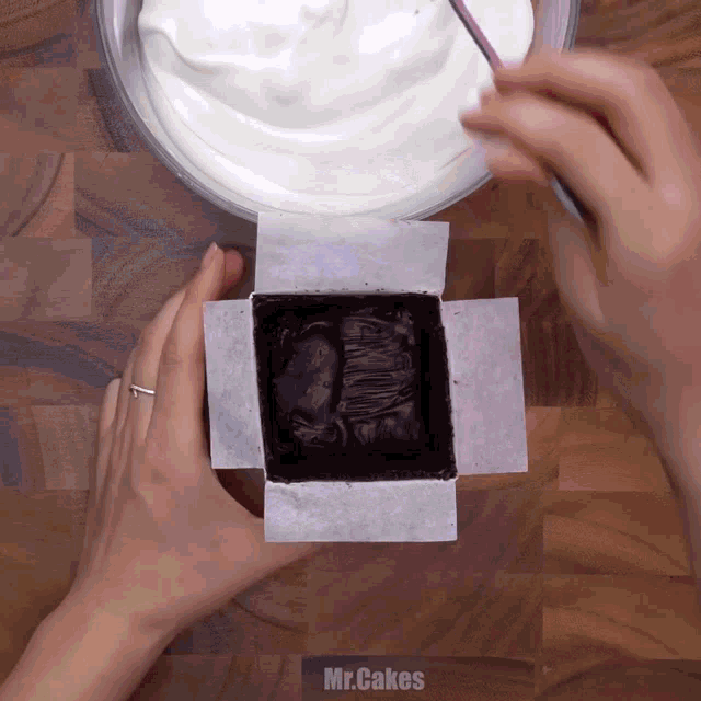 a person is preparing a cake with the words mr.cakes written on the bottom