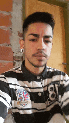 a man wearing a black and white striped shirt with the number 81 on it