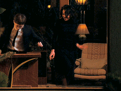 a man in a suit and tie is standing next to a woman