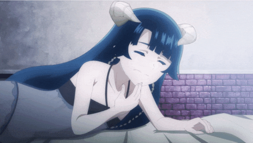 a girl with horns on her head is laying on the floor