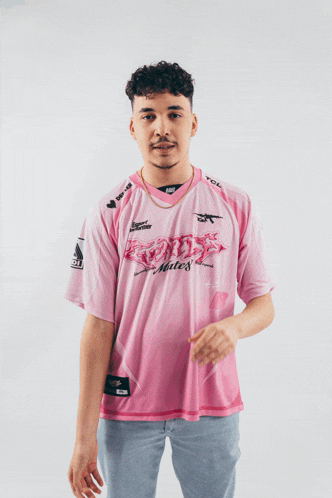 a man is wearing a pink shirt that says tcl on it