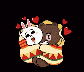 a brown bear and a white rabbit wrapped in a colorful blanket