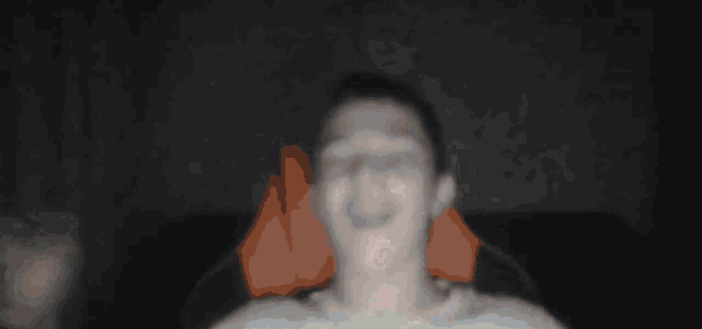 a blurry image of a man 's face with a red circle in the middle