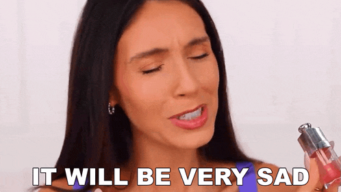 a woman is holding a lip gloss in her hand and crying .