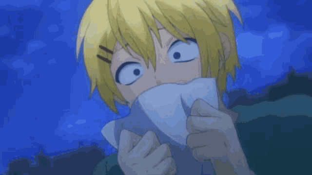 a person with yellow hair is covering their mouth with a white cloth