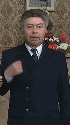 a man in a black shirt is covering his mouth with his hand