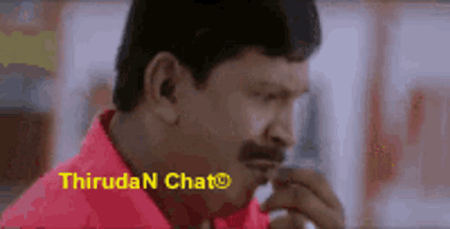 a man in a red shirt is talking on a cell phone with the words thiruda n chat below him
