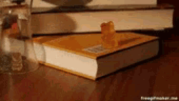 a gummy bear sits on top of a book