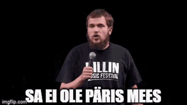 a man with a beard is holding a microphone and says " sa ei ole paris mees "