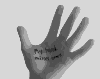 a person 's hand has the words " my hand misses yours " written on it