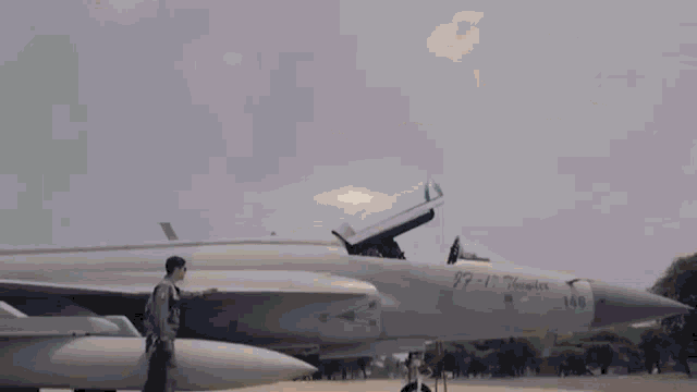 a man is sitting in the cockpit of a fighter jet