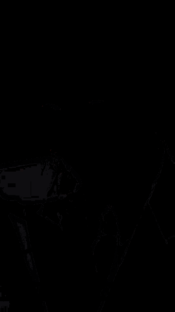 a woman wearing a suit and tie is talking in a foreign language