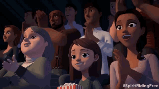 a group of people watching a movie with the hashtag #spiritridingfree on the bottom