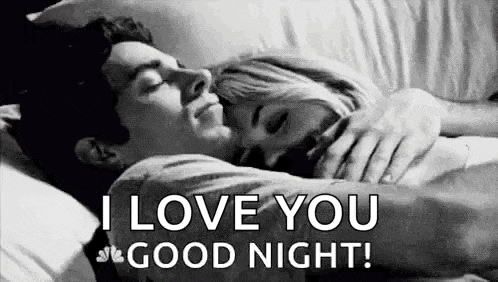a man and a woman are laying in bed hugging each other and the man is saying `` i love you good night '' .